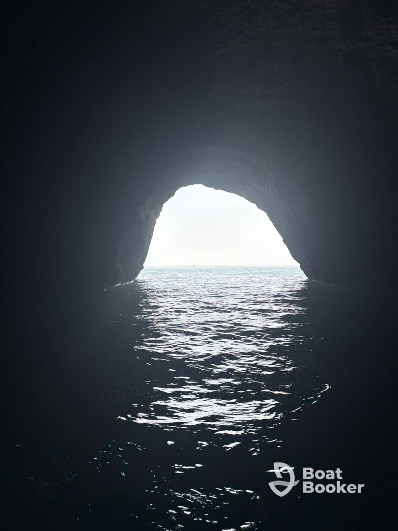 A stunning view of a cave opening leading to shimmering waters, showcasing a beautiful natural landmark perfect for exploration and adventure.