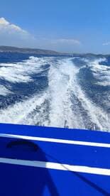 A dynamic view from the back of a speedboat, showcasing the wake and clear blue waters, perfect for thrilling water adventures.