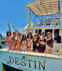 A lively group of friends celebrates aboard a yacht in Destin, Florida, enjoying cocktails and sunshine — perfect for unforgettable summer parties on the water.