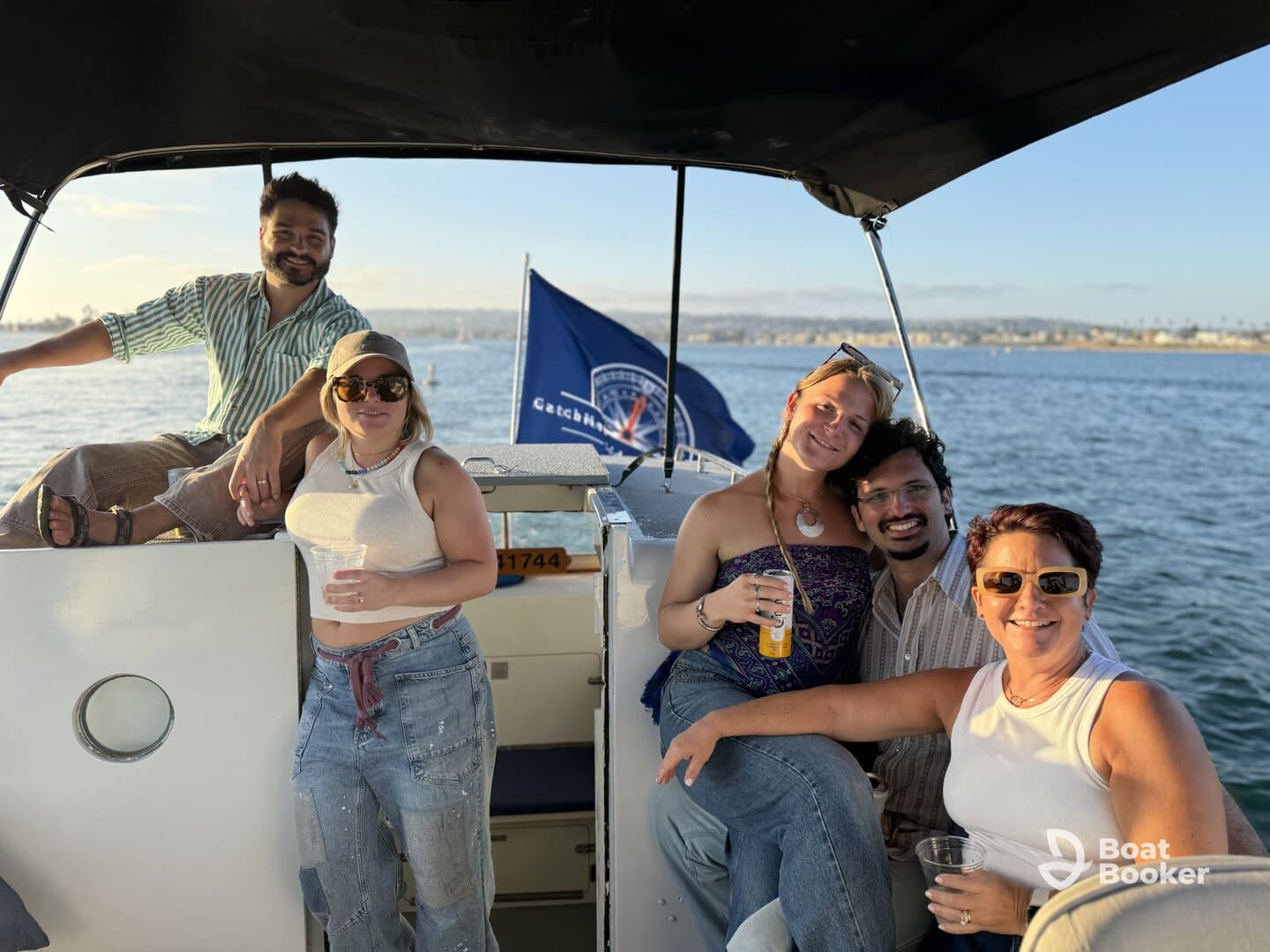 A cheerful group enjoys drinks on a boat, capturing the essence of a sunset cruise — perfect for celebrations and memorable outings on the water.