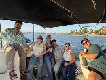 A cheerful group enjoys drinks and camaraderie aboard a boat, capturing the essence of a fun-filled day on the water.