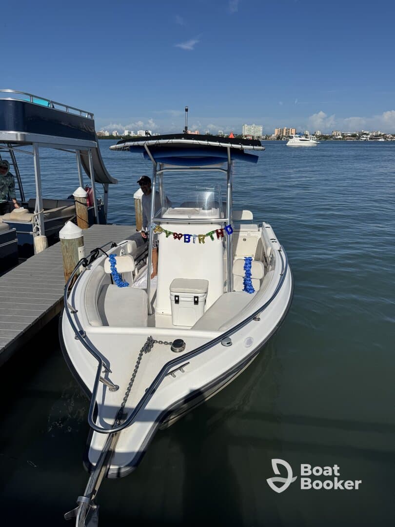 A speedboat docked at the marina, adorned with a birthday banner, showcasing a festive atmosphere perfect for celebrations on the water.
