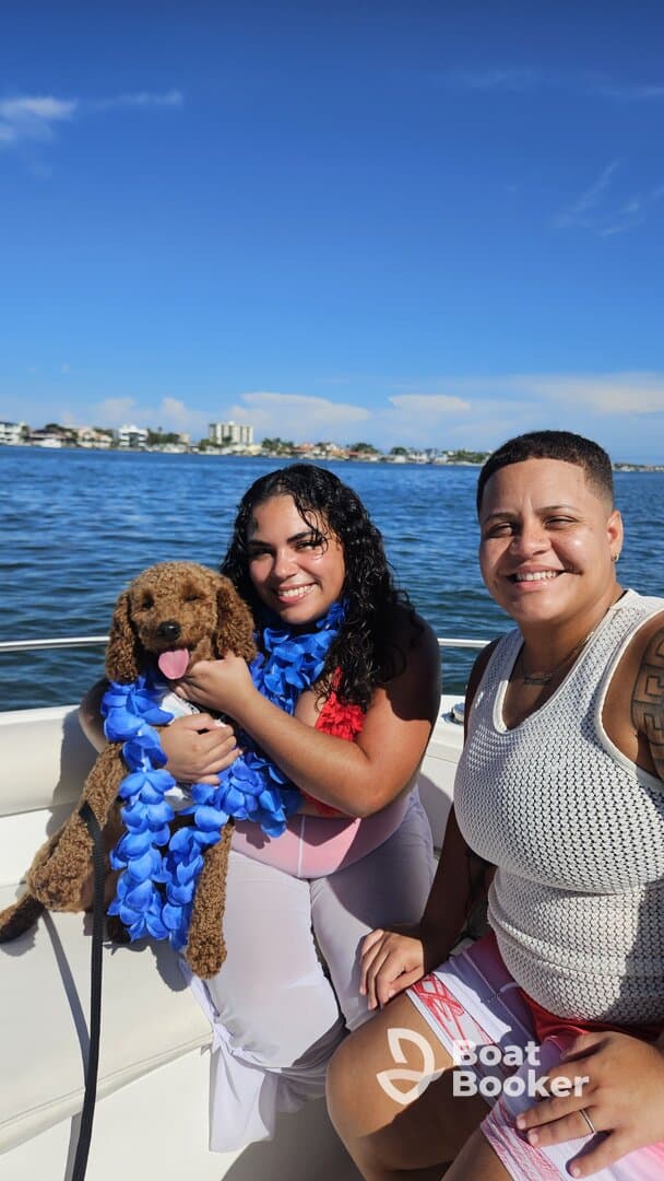 A joyful moment on the water with friends and a dog, showcasing a fun day out on the boat — perfect for memorable celebrations.