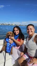 A joyful moment on the water with friends and a dog, showcasing a fun day out on the boat — perfect for memorable celebrations.