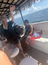 Guests relax inside a boat cabin, enjoying the spacious seating and scenic views of the water. Perfect for group outings and leisurely cruises.
