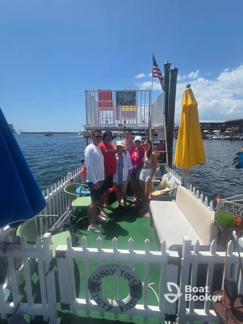 A lively group gathers on a boat deck, enjoying a sunny day on the water — perfect for celebrations and memorable outings.