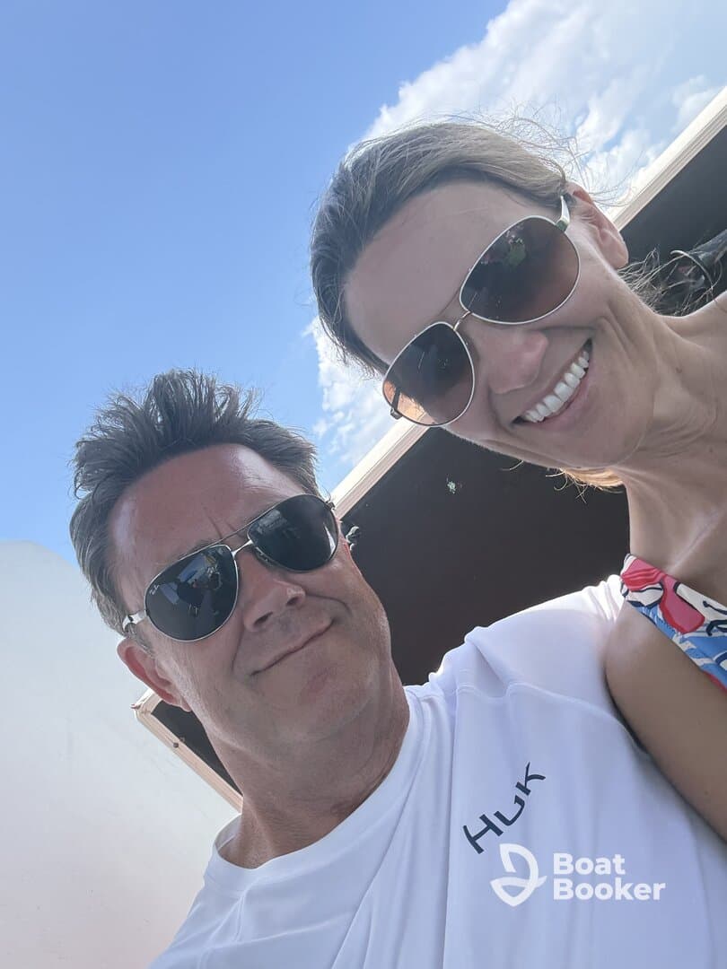 A happy couple enjoys their time on a boat, capturing a sunny moment with smiles and sunglasses — perfect for romantic getaways or fun outings on the water.
