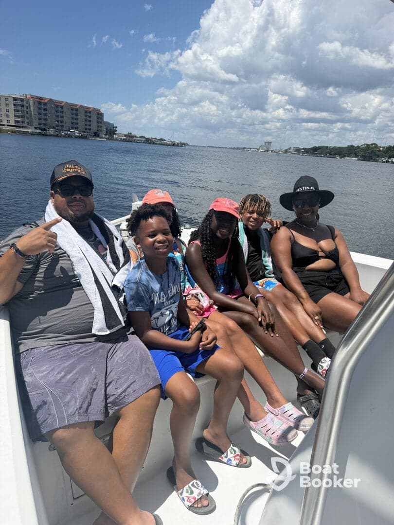 A joyful family enjoys a sunny day on the boat, capturing the essence of summer fun and togetherness on the water.