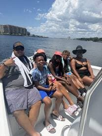 A joyful family enjoys a sunny day on the boat, capturing the essence of summer fun and togetherness on the water.