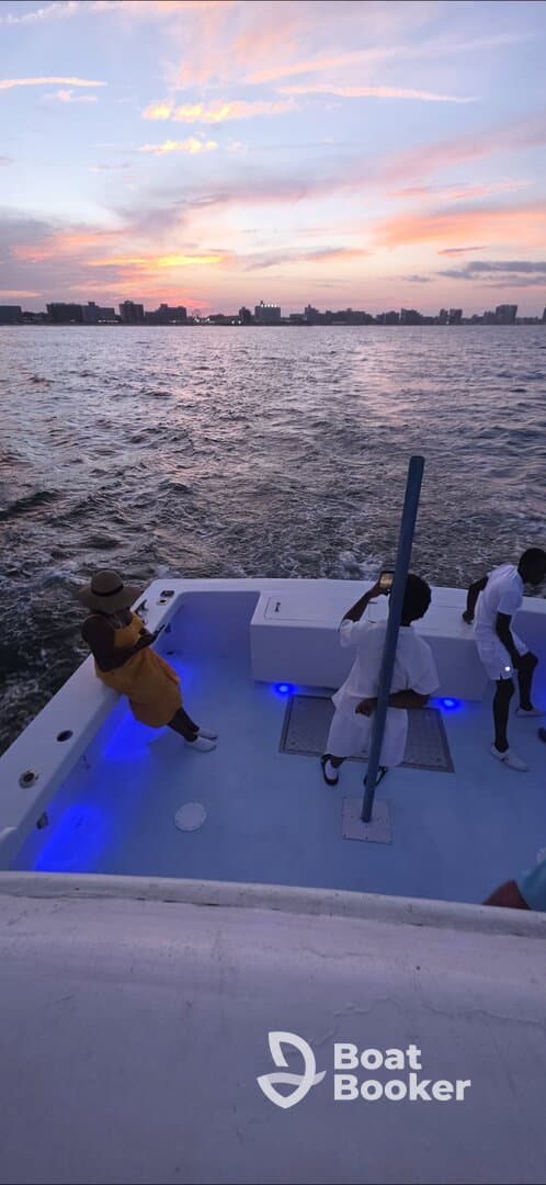 A group enjoys a beautiful sunset aboard a boat, creating a perfect backdrop for memorable celebrations on the water.