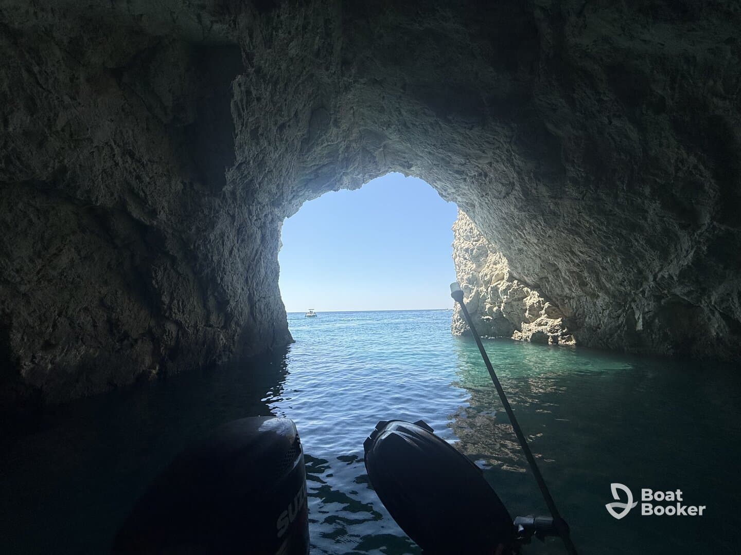 A stunning view from inside a cave looking out towards the ocean, showcasing the beautiful turquoise waters and rocky formations — perfect for adventure seekers exploring coastal landscapes.