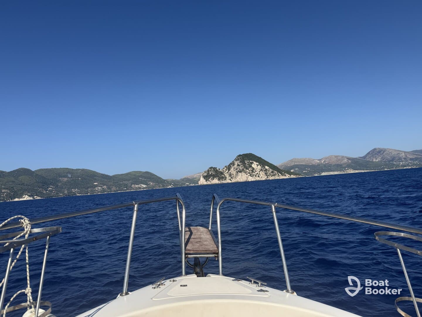 A stunning view from the bow of a boat cruising through deep blue waters, with picturesque islands in the background — perfect for exploring coastal destinations.