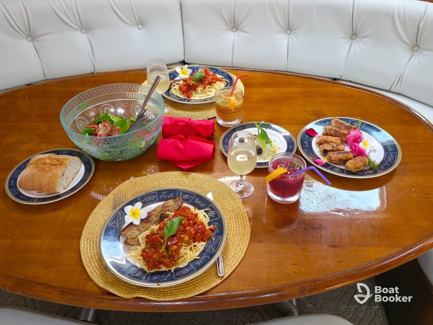 A beautifully arranged dining table on a boat featuring gourmet dishes and refreshing cocktails, perfect for an upscale dining experience on the water.
