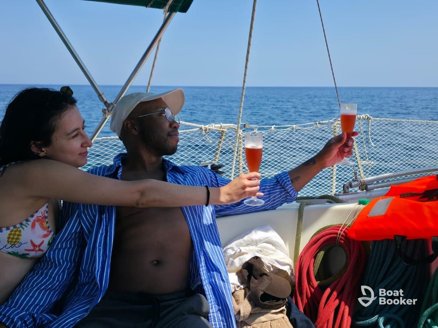 A couple enjoys a toast with cocktails aboard a yacht, capturing a perfect moment of celebration on the open water.