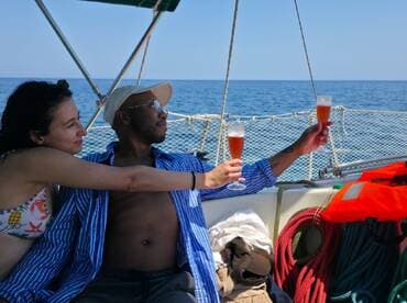A couple enjoys a toast with cocktails aboard a yacht, capturing a perfect moment of celebration on the open water.