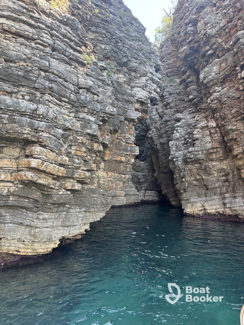 A stunning view of rocky cliffs framing a serene waterway, perfect for exploring hidden coves and enjoying nature's beauty.
