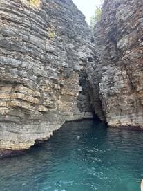 A stunning view of rocky cliffs framing a serene waterway, perfect for exploring hidden coves and enjoying nature's beauty.