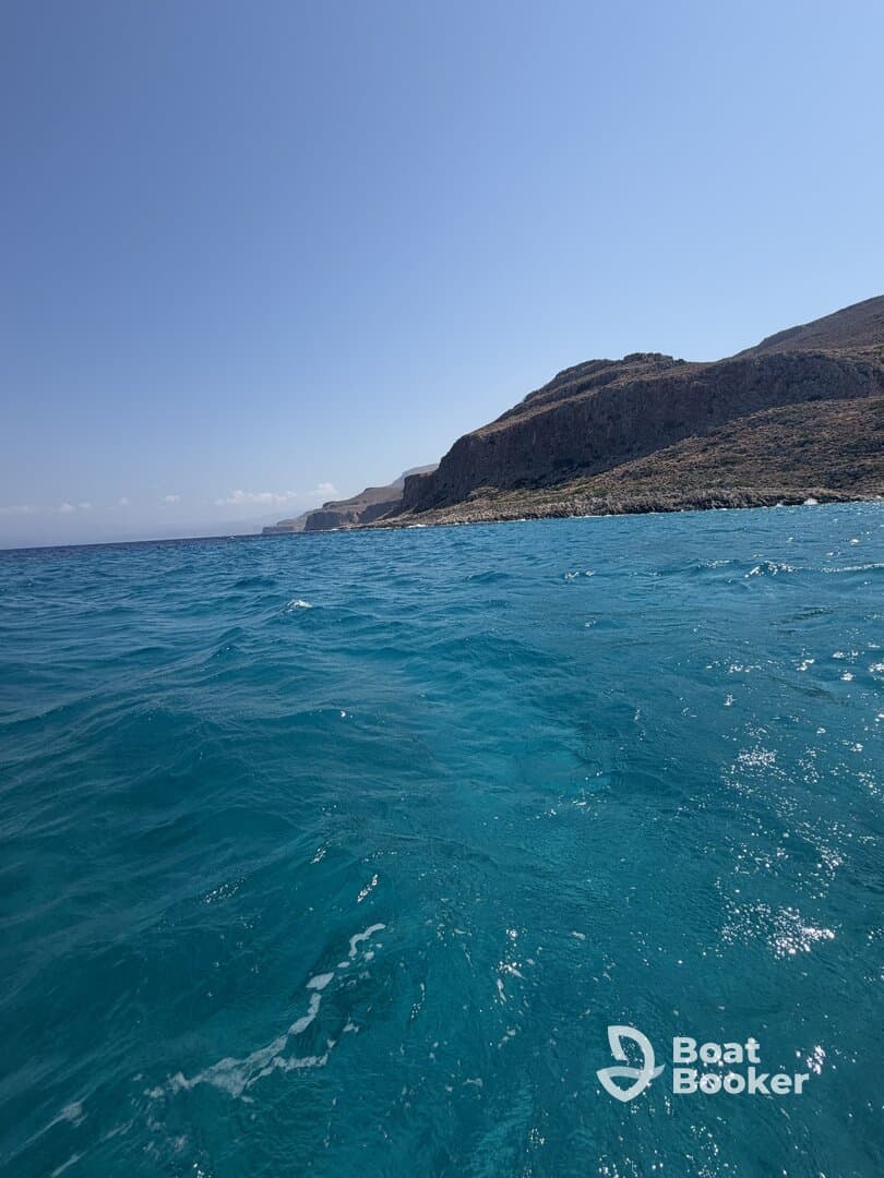 A stunning view of the coastline with vibrant blue waters, perfect for showcasing the beauty of a boating adventure.
