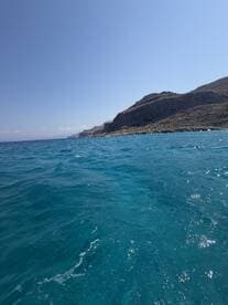 A stunning view of the coastline with vibrant blue waters, perfect for showcasing the beauty of a boating adventure.