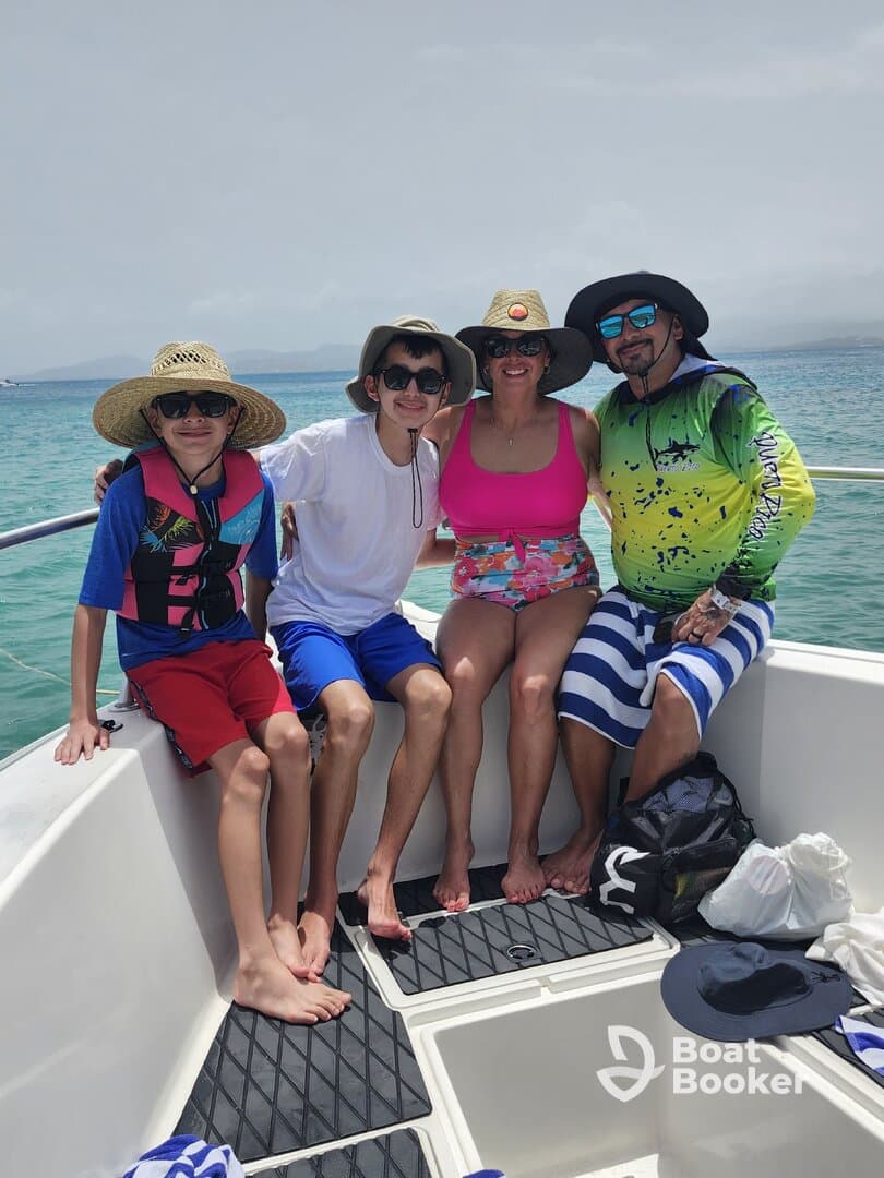 A cheerful family poses together on a boat, enjoying a sunny day on the water — perfect for creating lasting memories during their aquatic adventure.