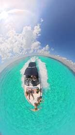 A lively group enjoys a fun day on the water, soaking up the sun aboard a boat in stunning turquoise waters — perfect for unforgettable adventures and family outings.