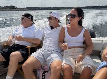 A group of friends relaxes on a boat, enjoying the sun and water — perfect for a day out on the waves.