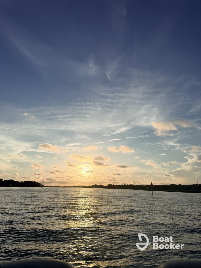 A stunning sunset over tranquil waters, capturing the beauty of nature and the serene coastline — perfect for romantic evenings or peaceful reflections.