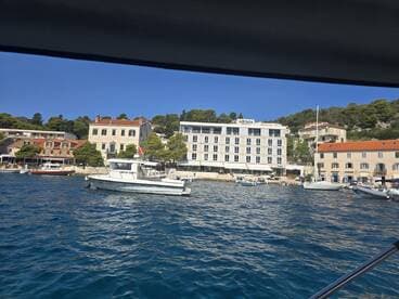 A picturesque view of a harbor with various boats and charming coastal buildings, perfect for showcasing the beauty of waterfront destinations.