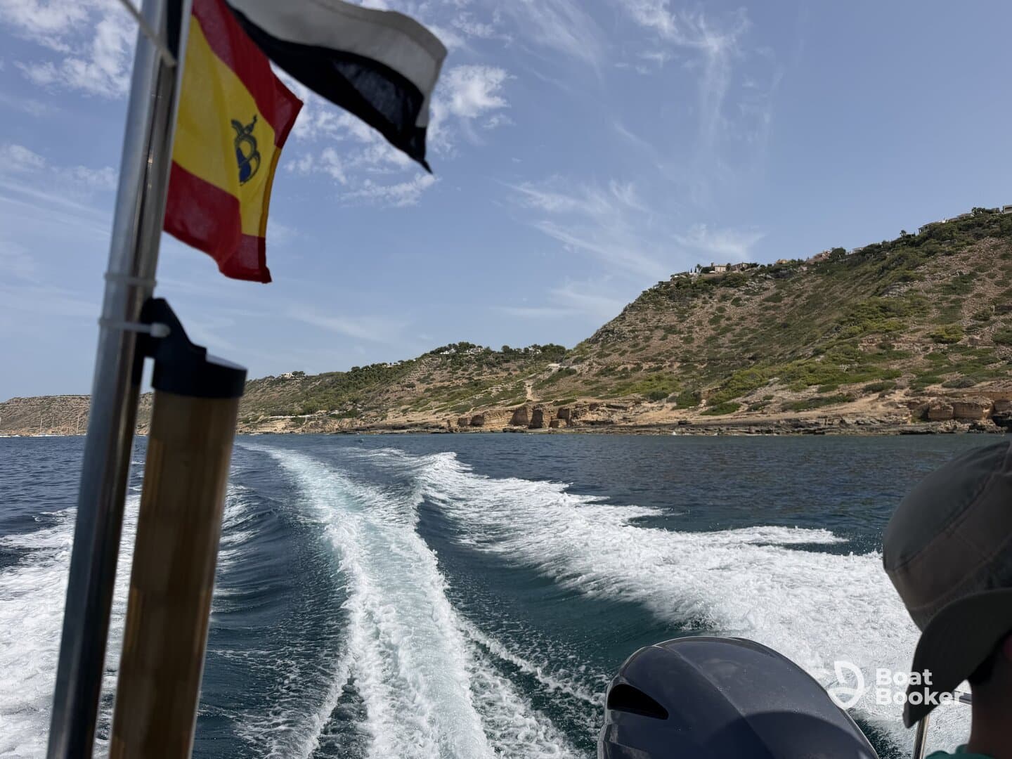 A scenic view from a boat, showcasing the coastline and waves, perfect for capturing the essence of a day on the water.