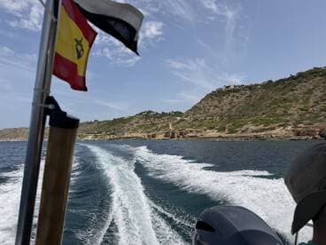 A scenic view from a boat, showcasing the coastline and waves, perfect for capturing the essence of a day on the water.