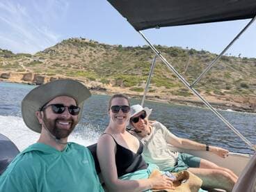 A cheerful group enjoys a sunny day on a boat, capturing the joy of outdoor adventures and camaraderie on the water.