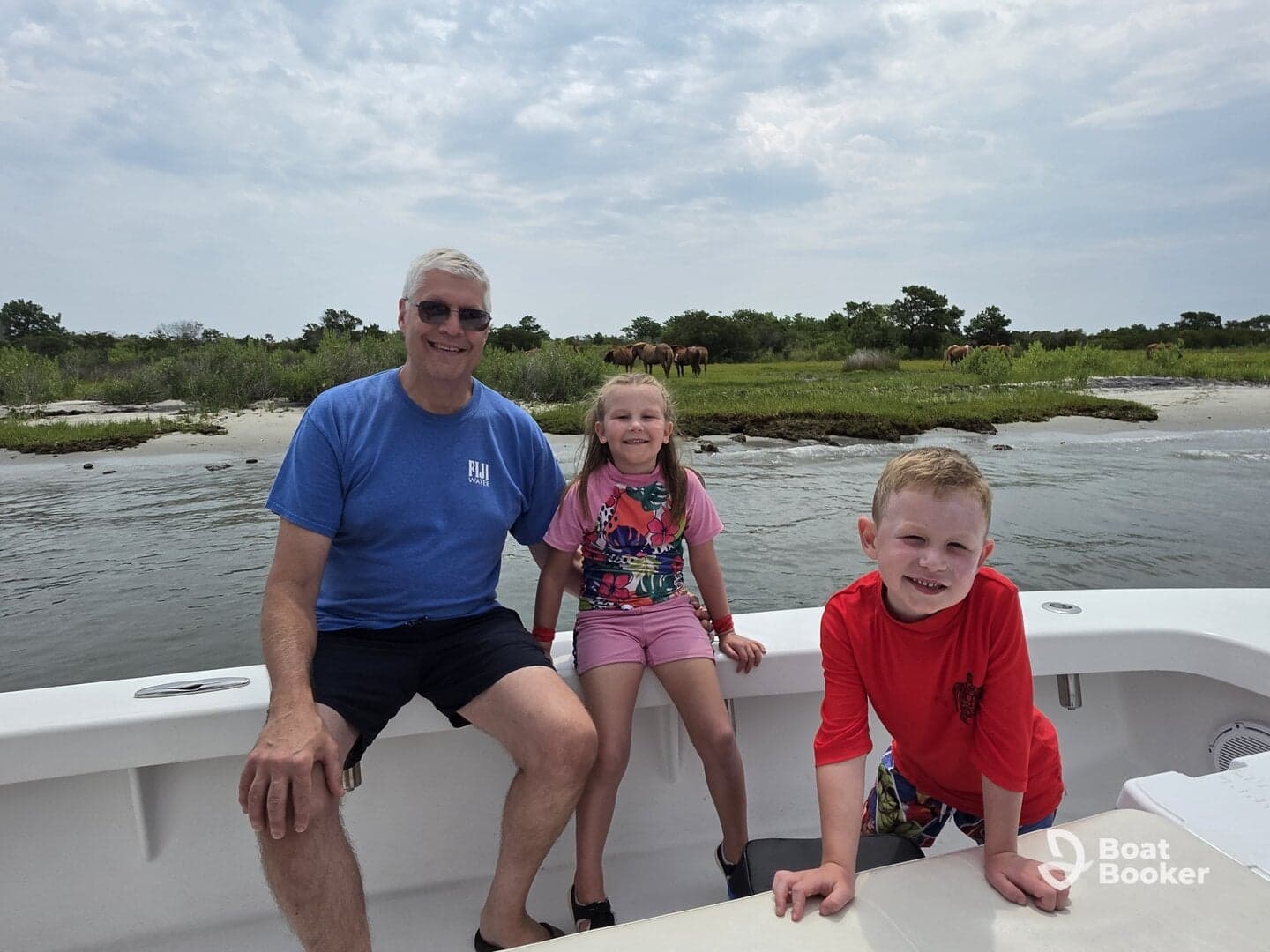 A joyful family moment on a boat, with children smiling and enjoying the scenic view of nature in the background — perfect for family outings and adventures on the water.