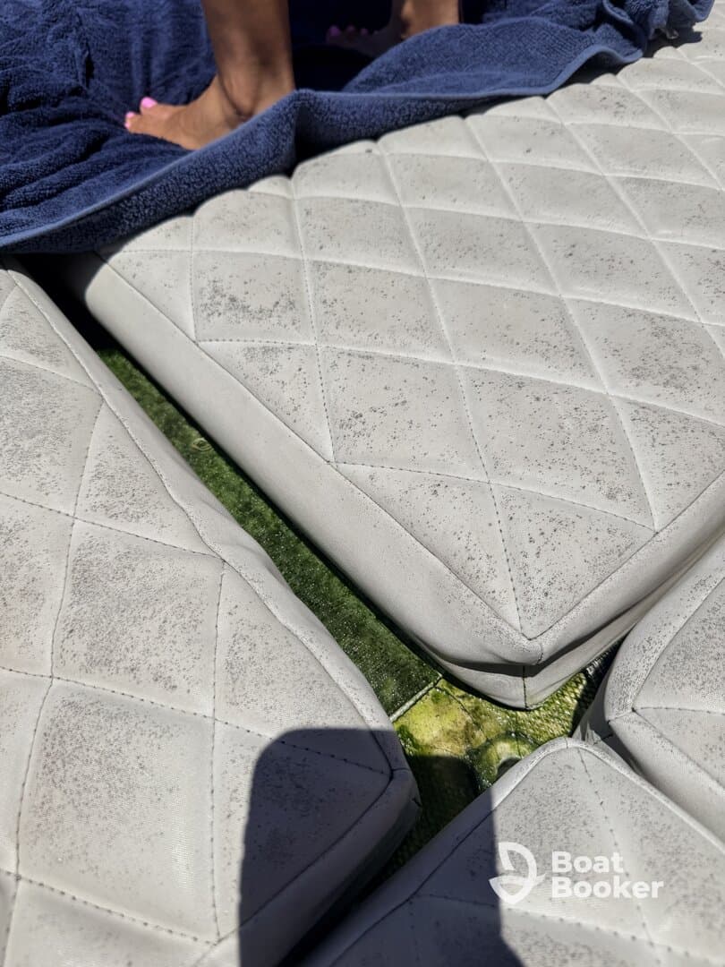 Close-up of boat seating with a towel, showcasing the comfortable lounging area perfect for relaxing on the water.