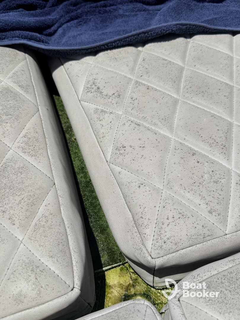 Close-up of boat seating showing wear and tear, ideal for assessing onboard amenities and comfort.