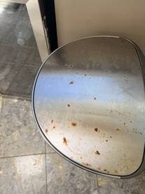 An unclear image showing a surface with stains, possibly indicating maintenance issues. The context of the image is not easily identifiable.