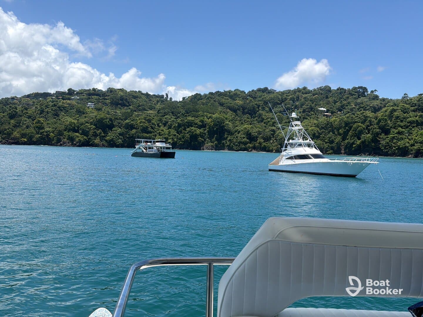 A stunning view of two boats anchored in tranquil waters, surrounded by lush greenery — perfect for a day of relaxation on the water.