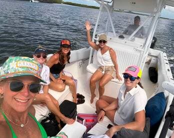 A lively group of friends enjoys a fun day on the water aboard a boat, capturing the joy of their outing with smiles and camaraderie.
