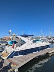 A stunning Fairline yacht docked at the marina, showcasing its sleek design against a clear blue sky — perfect for luxury boating experiences.