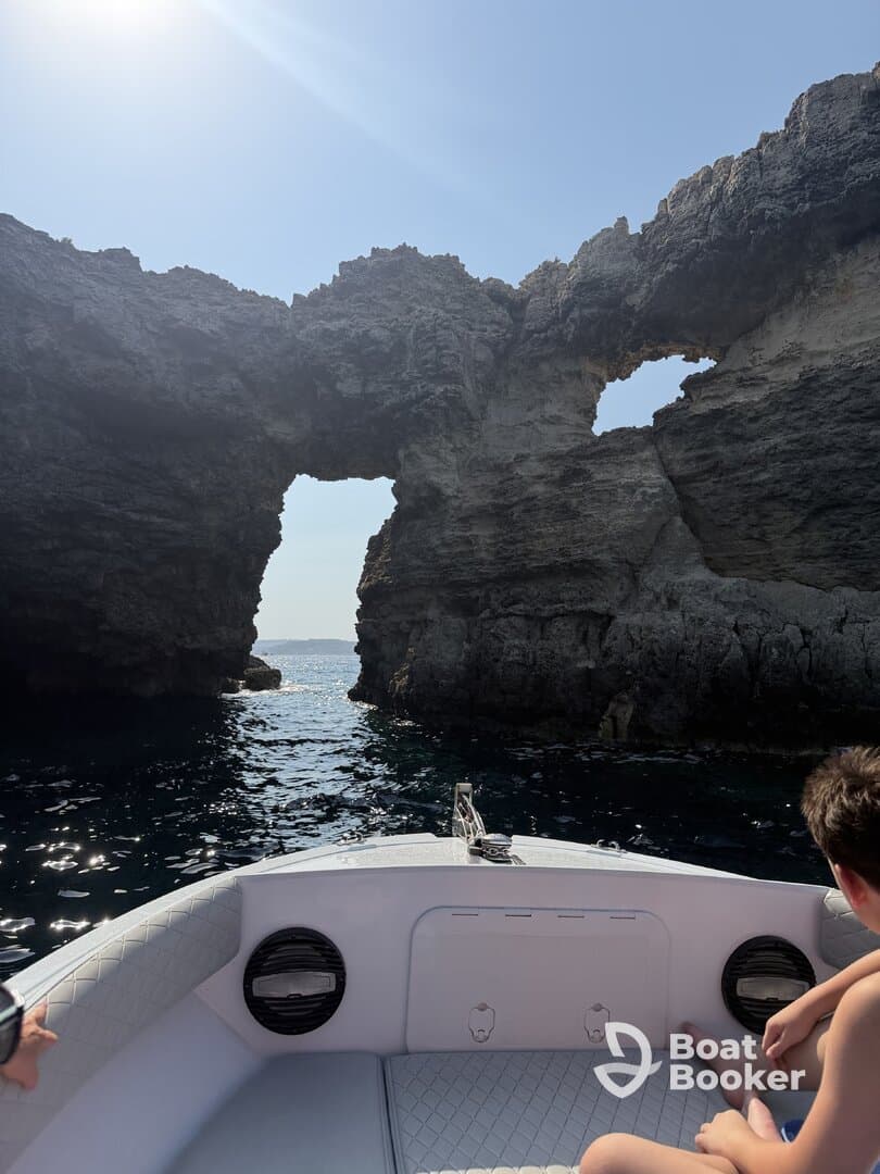 A scenic view of a boat navigating through a stunning rock formation, perfect for exploration and adventure on the water.
