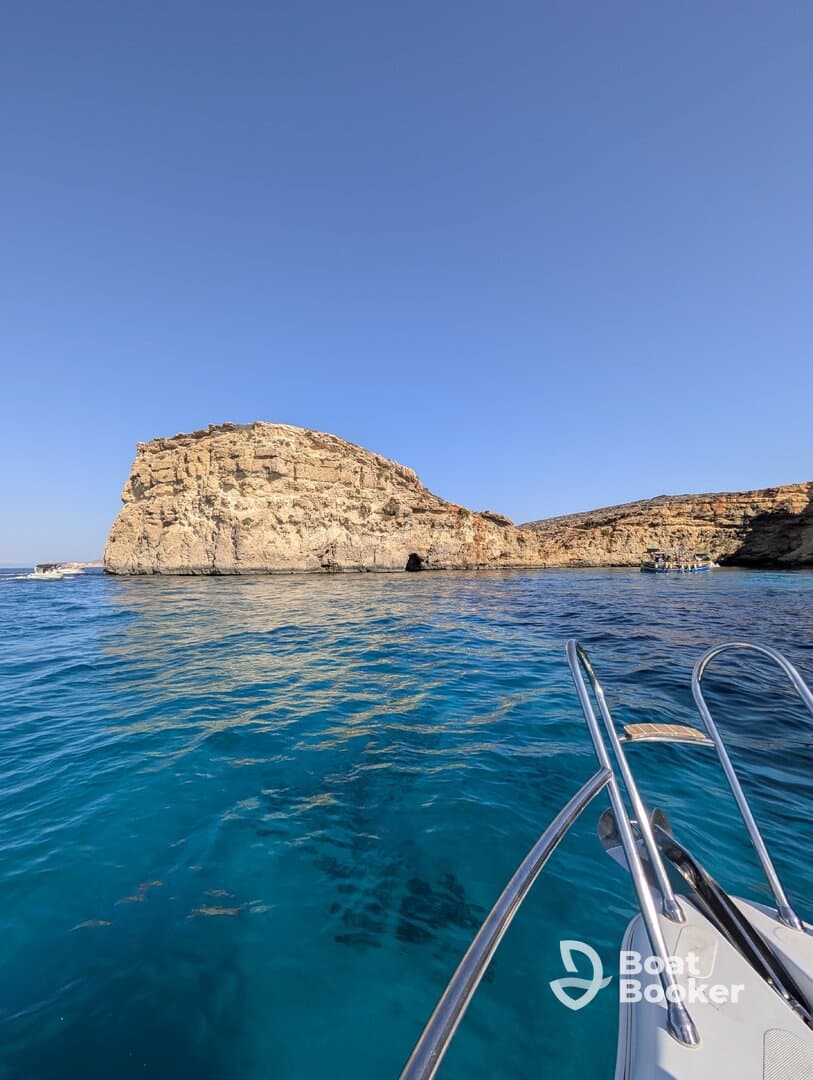 A stunning view of a rocky coastline with crystal-clear waters, perfect for exploring and enjoying the natural beauty of the area.