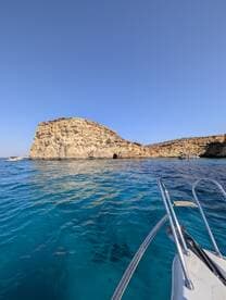 A stunning view of a rocky coastline with crystal-clear waters, perfect for exploring and enjoying the natural beauty of the area.