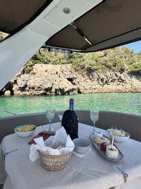 A beautifully arranged table on a boat featuring a selection of gourmet snacks and drinks, perfect for a relaxing day on the water.