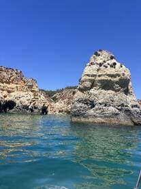 A stunning view of unique rock formations along the coastline, showcasing the natural beauty of the area — perfect for sightseeing and exploring by boat.