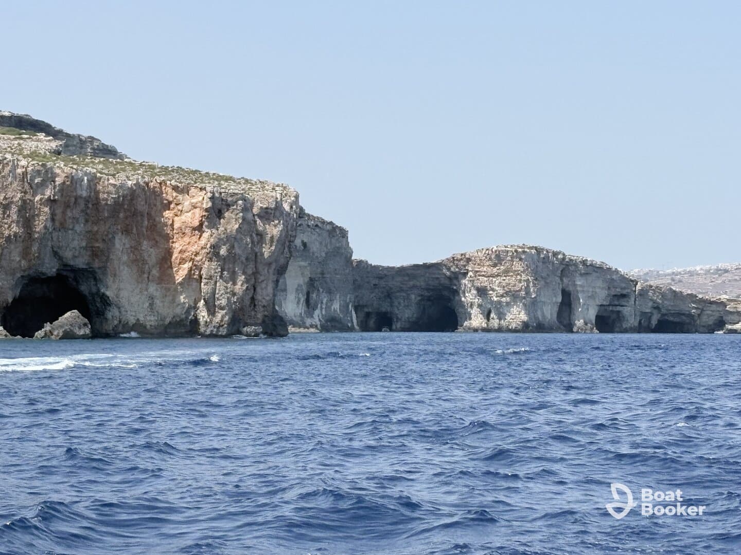 A stunning view of coastal caves along the shoreline, showcasing the natural beauty of the ocean and rock formations — perfect for sightseeing and exploration.