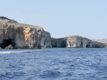 A stunning view of coastal caves along the shoreline, showcasing the natural beauty of the ocean and rock formations — perfect for sightseeing and exploration.