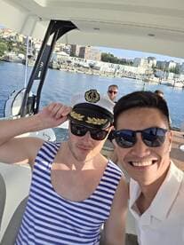 Two friends take a cheerful selfie aboard a boat, capturing a fun moment on the water — perfect for celebrating special occasions or enjoying a day out with friends.