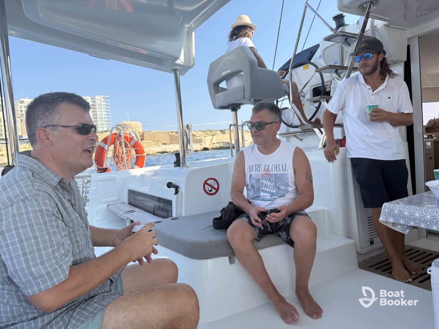 A group of friends enjoys a relaxed moment aboard a boat, engaging in conversation and soaking up the sun — perfect for a day on the water.