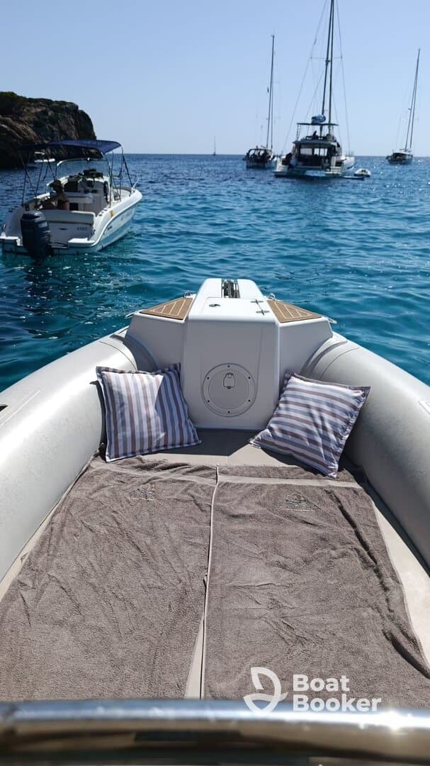 A cozy interior view of a boat featuring plush pillows and towels, perfect for relaxing on the water. Ideal for those seeking comfort during their nautical adventures.