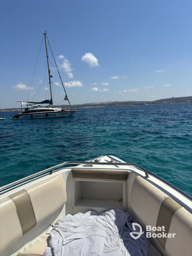 A serene view of a yacht anchored in clear blue waters, showcasing the beauty of a day on the water.