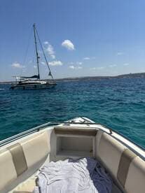 A serene view of a yacht anchored in clear blue waters, showcasing the beauty of a day on the water.